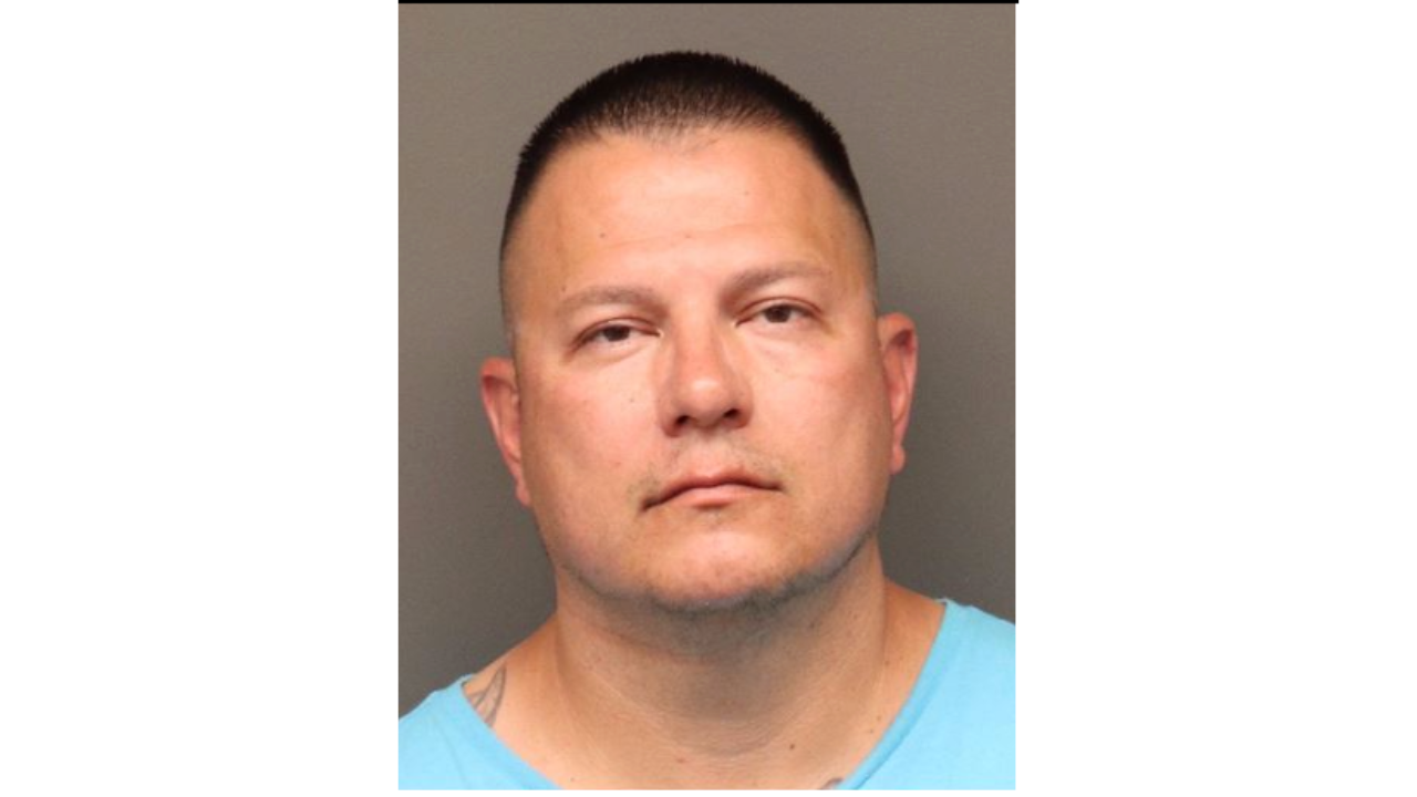 Robert-Jake-Chavez.png; a man in a blue shirt facing forward with a neutral expression