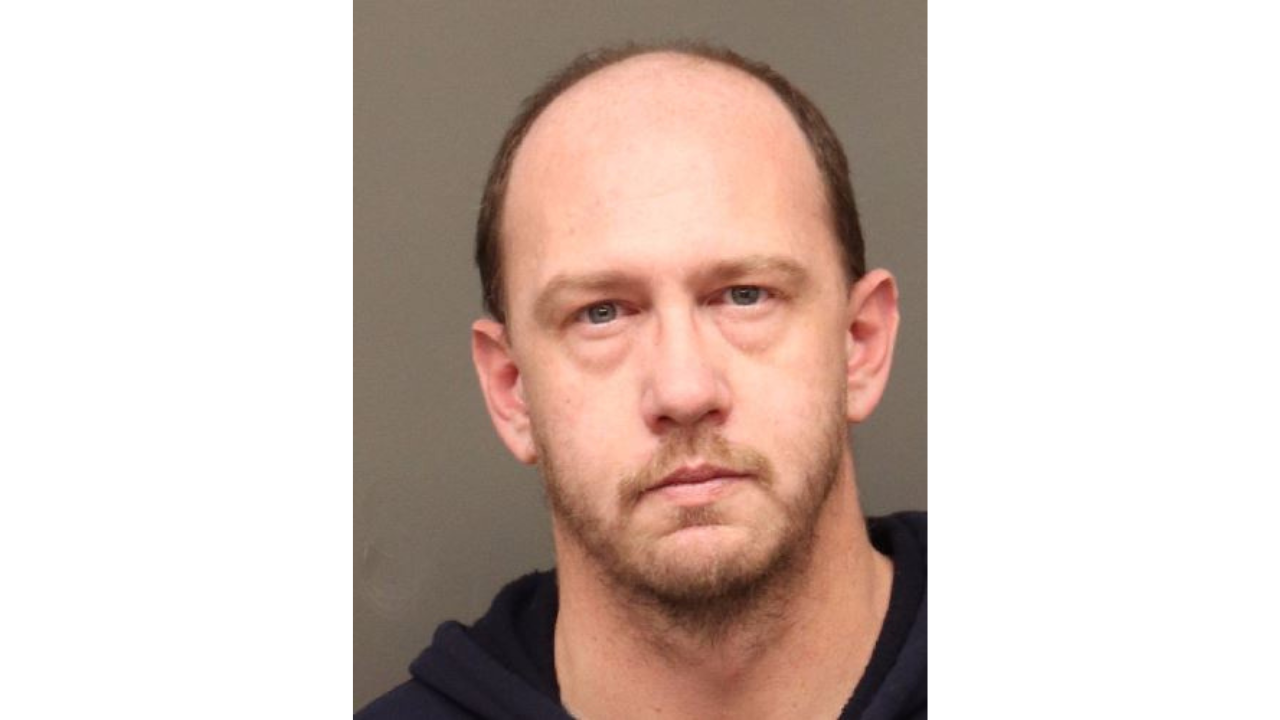 Todd-Williamson.png showing a serious expression in front of a neutral background