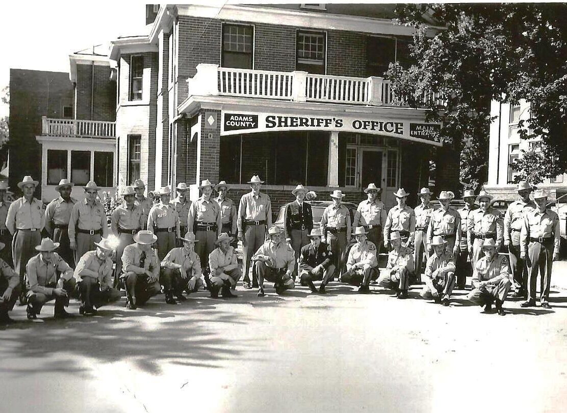 Officers posed outside Adams County Sheriff's Office, historic photograph